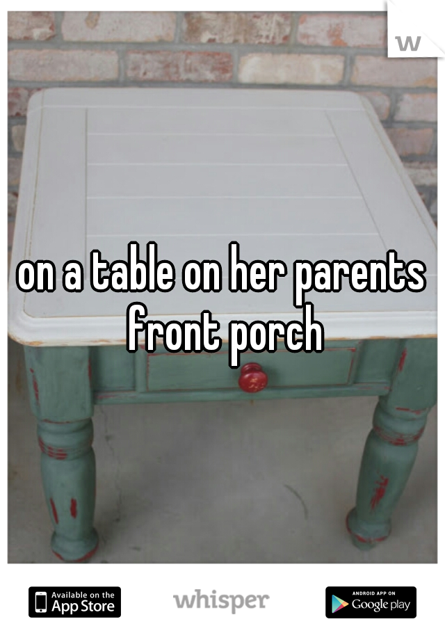 on a table on her parents front porch