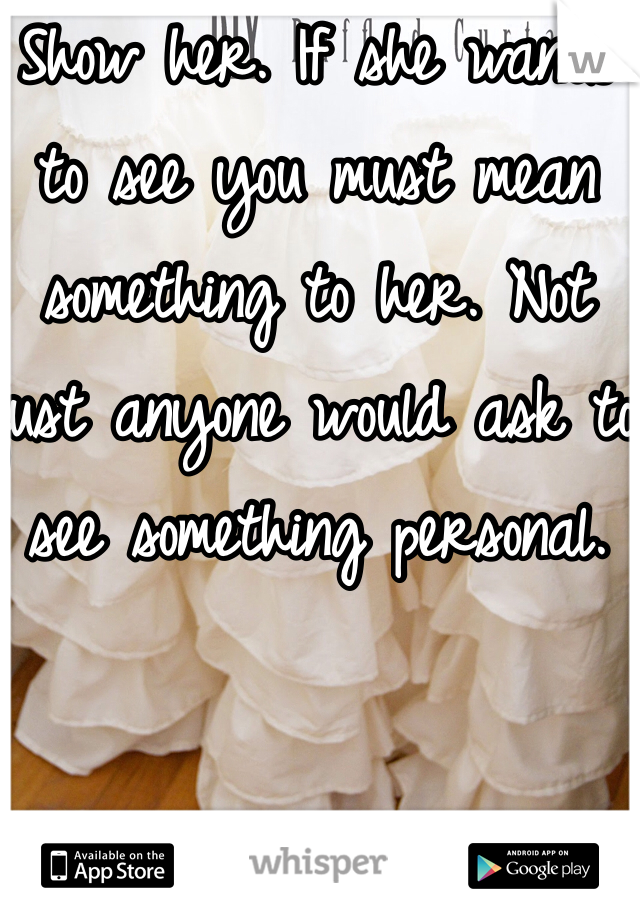 Show her. If she wants to see you must mean something to her. Not just anyone would ask to see something personal. 