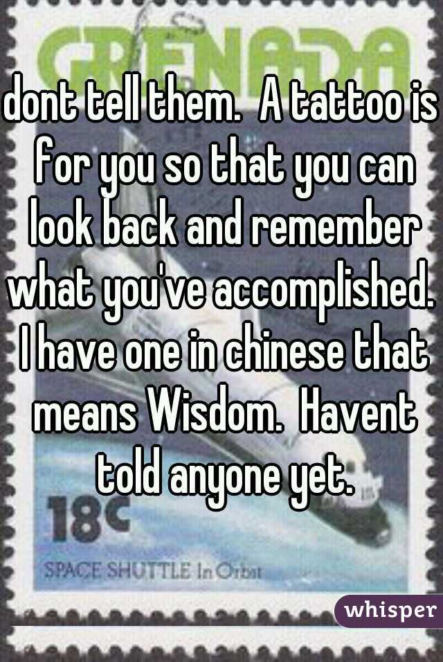 dont tell them.  A tattoo is for you so that you can look back and remember what you've accomplished.  I have one in chinese that means Wisdom.  Havent told anyone yet.