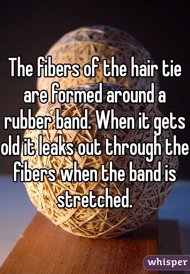 The fibers of the hair tie are formed around a rubber band. When it gets old it leaks out through the fibers when the band is stretched. 