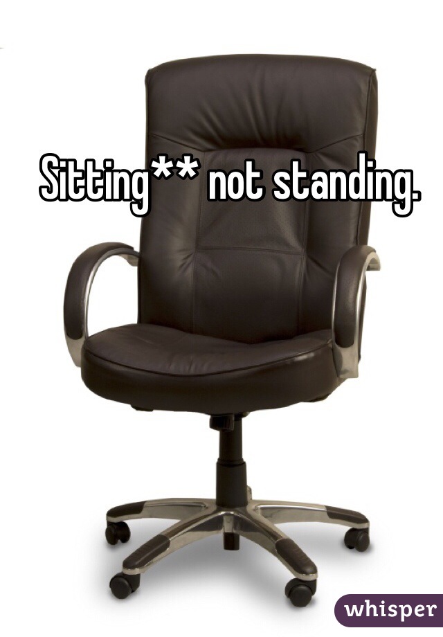 Sitting** not standing.