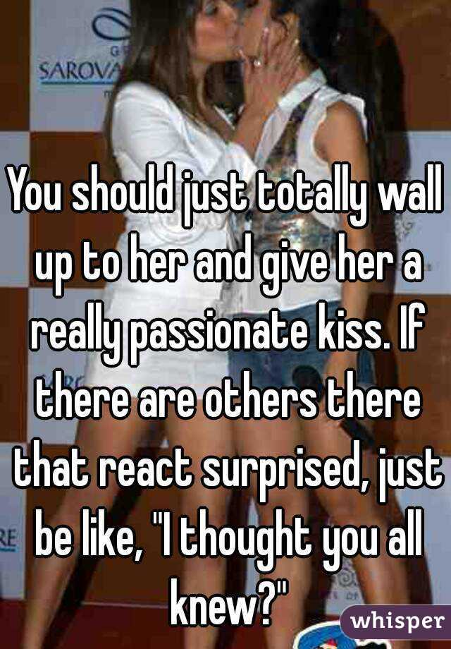 You should just totally wall up to her and give her a really passionate kiss. If there are others there that react surprised, just be like, "I thought you all knew?"