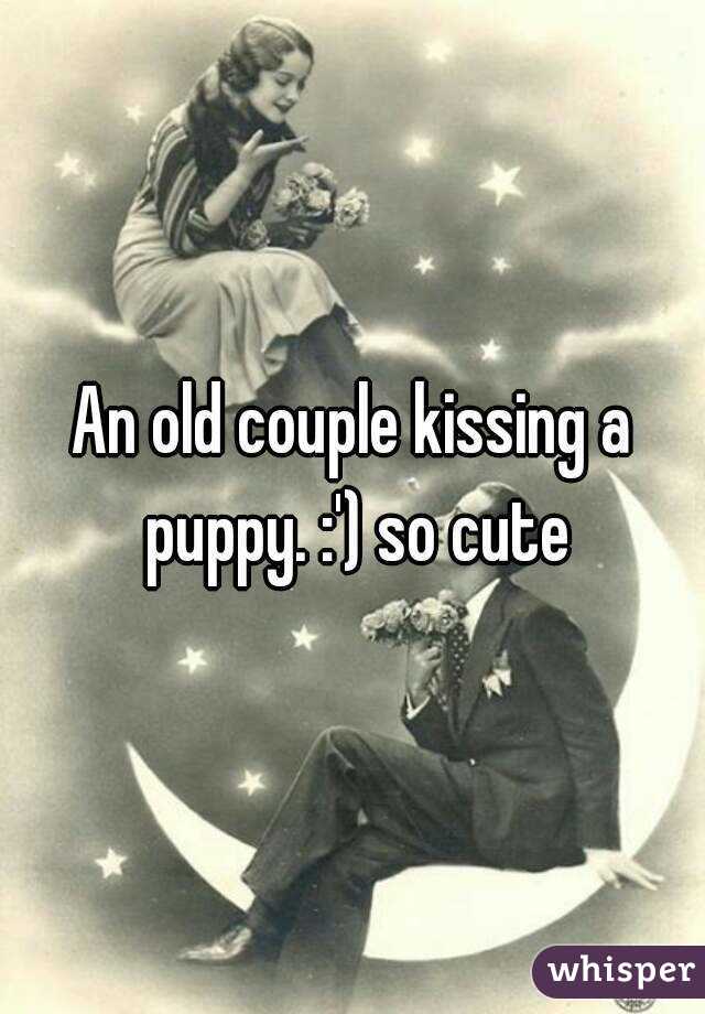 An old couple kissing a puppy. :') so cute