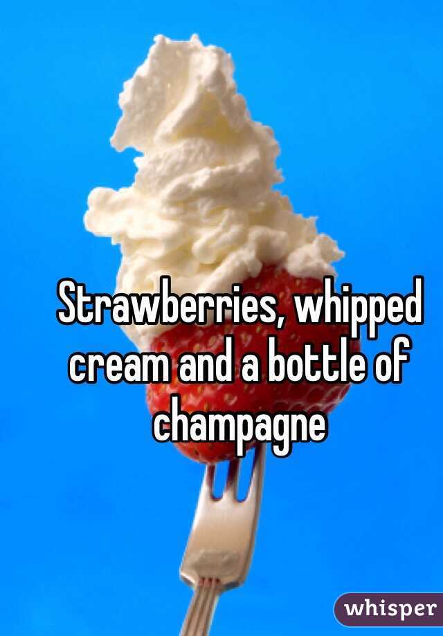 Strawberries, whipped cream and a bottle of champagne 