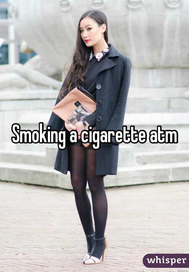 Smoking a cigarette atm