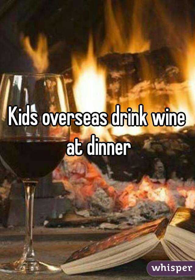 Kids overseas drink wine at dinner