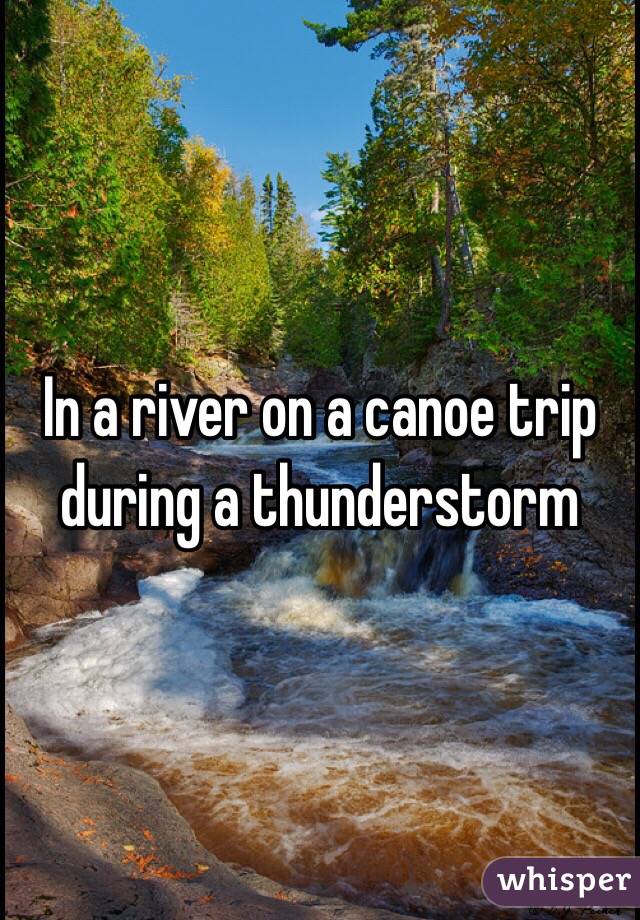 In a river on a canoe trip during a thunderstorm
