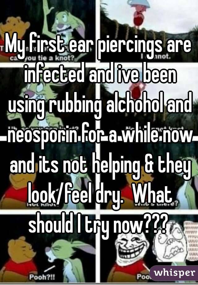 My first ear piercings are infected and ive been using rubbing alchohol and neosporin for a while now and its not helping & they look/feel dry.  What should I try now??? 