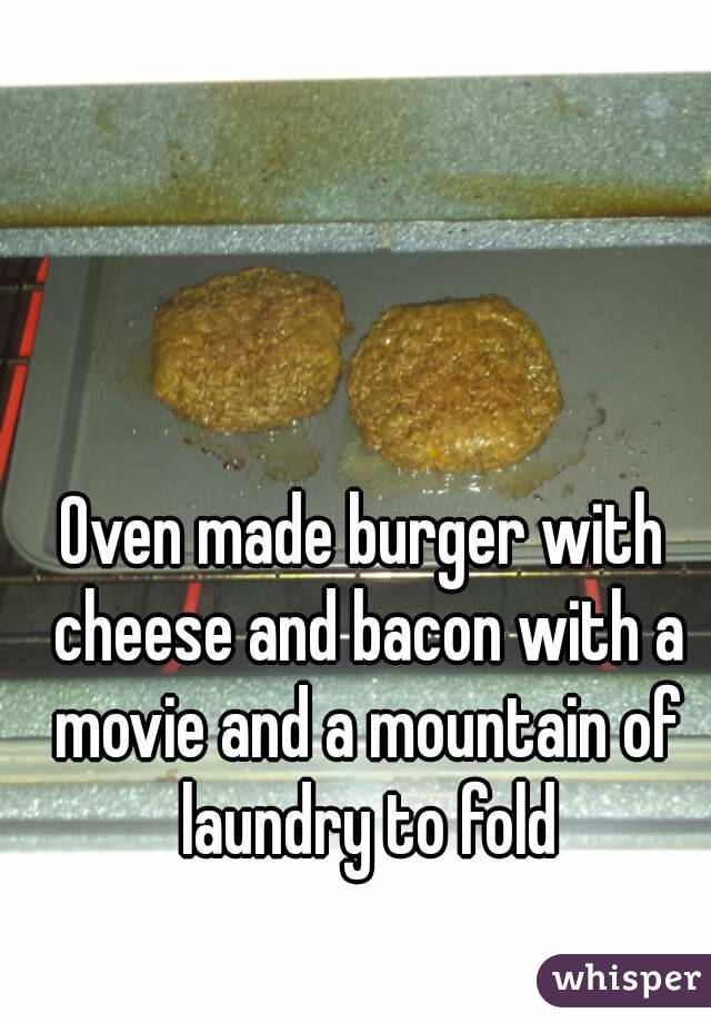 Oven made burger with cheese and bacon with a movie and a mountain of laundry to fold