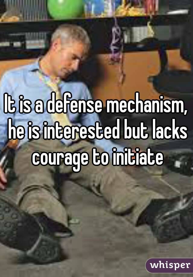It is a defense mechanism, he is interested but lacks courage to initiate