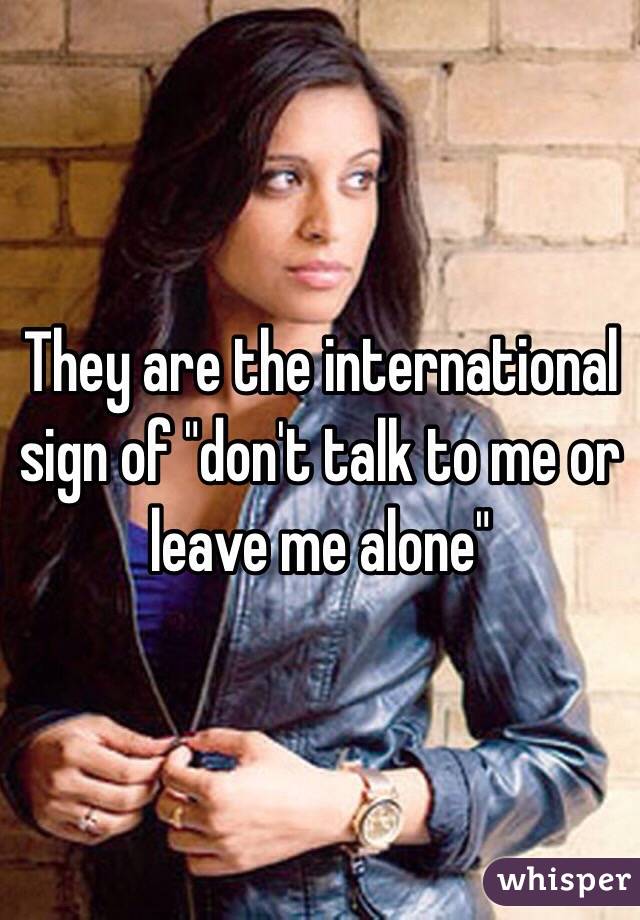 They are the international sign of "don't talk to me or leave me alone"