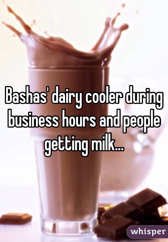 Bashas' dairy cooler during business hours and people getting milk...