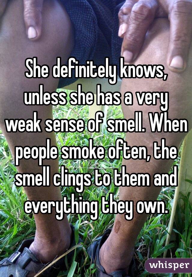 She definitely knows, unless she has a very weak sense of smell. When people smoke often, the smell clings to them and everything they own.