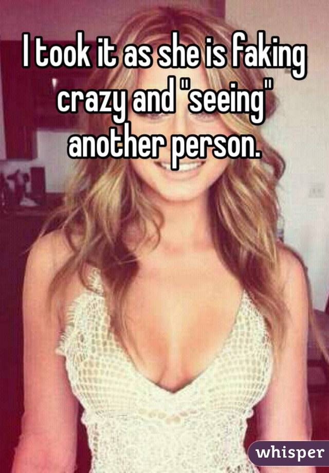 I took it as she is faking crazy and "seeing" another person. 
