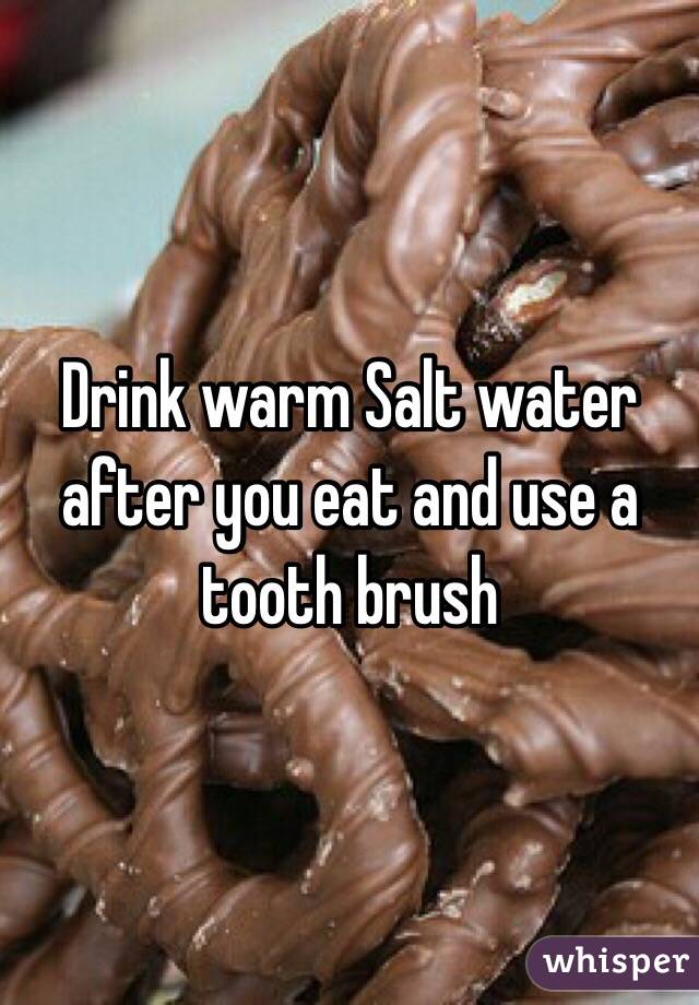 Drink warm Salt water after you eat and use a tooth brush 