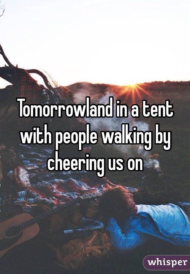Tomorrowland in a tent with people walking by cheering us on 