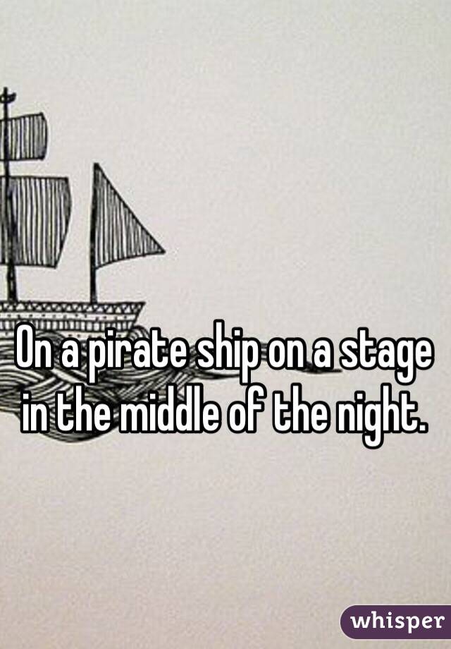 On a pirate ship on a stage in the middle of the night.