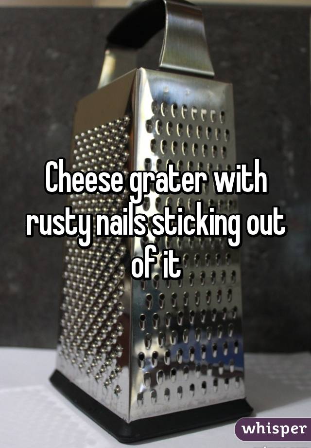 Cheese grater with rusty nails sticking out of it