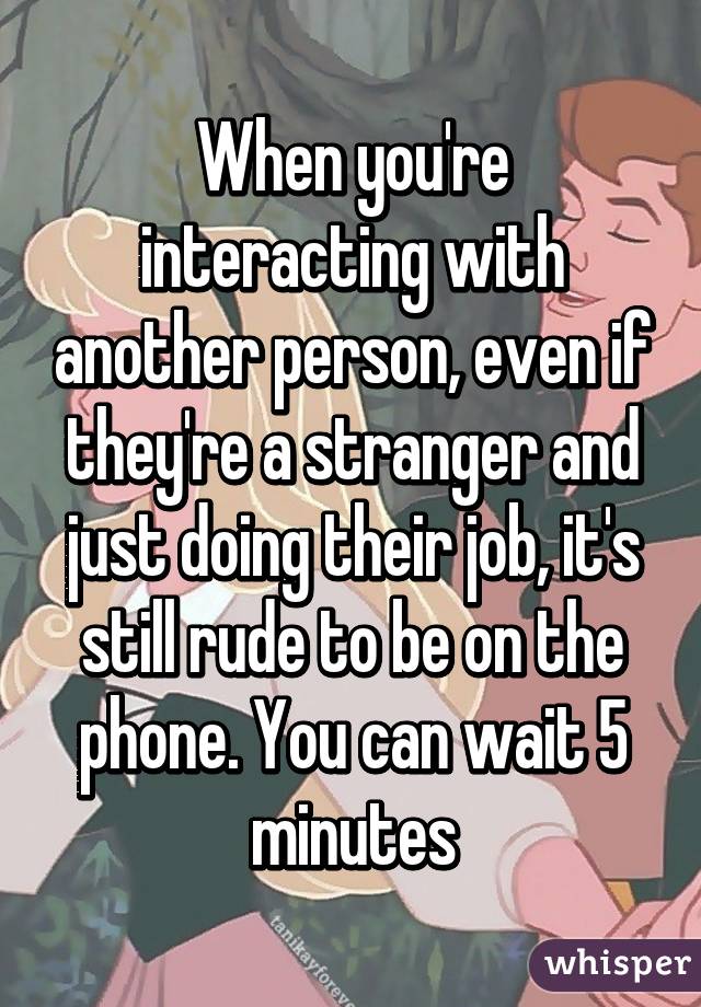 When you're interacting with another person, even if they're a stranger and just doing their job, it's still rude to be on the phone. You can wait 5 minutes