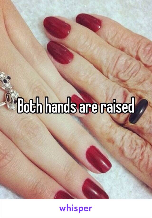 Both hands are raised