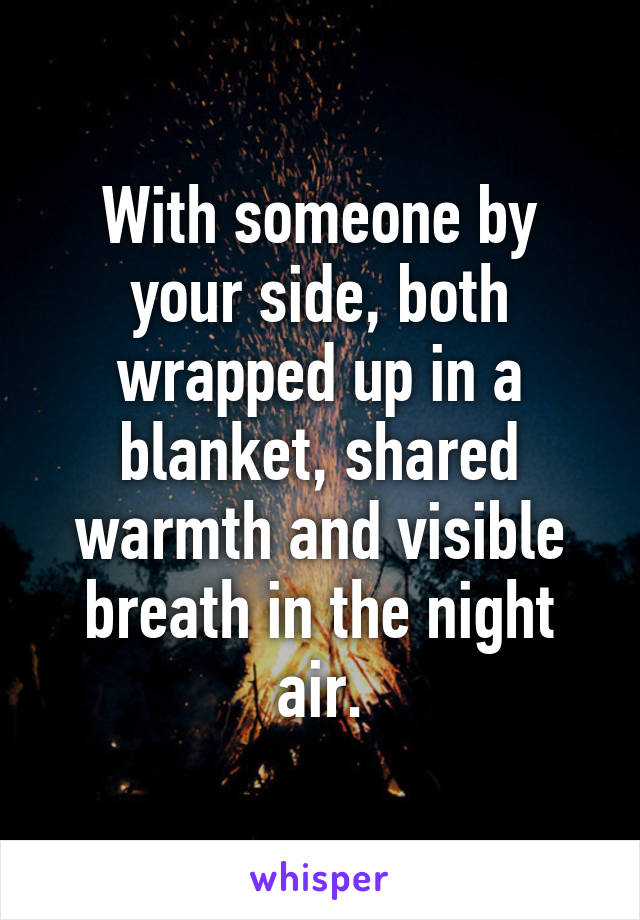 With someone by your side, both wrapped up in a blanket, shared warmth and visible breath in the night air.
