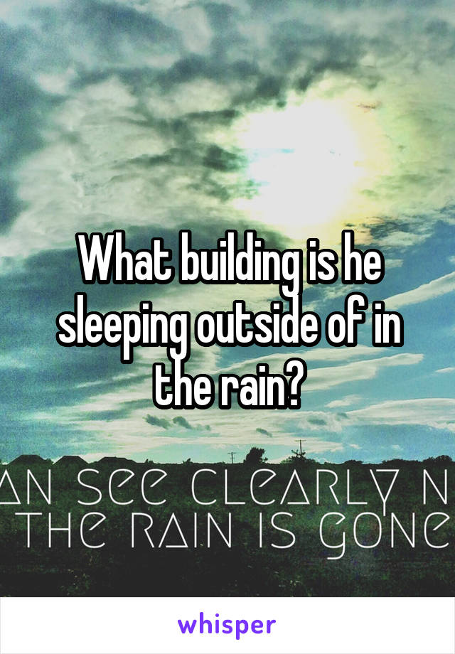 What building is he sleeping outside of in the rain?