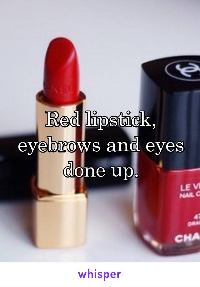 Red lipstick, eyebrows and eyes done up.