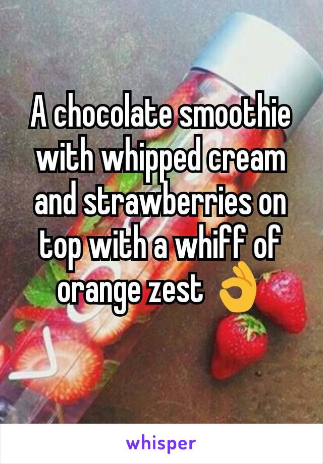 A chocolate smoothie with whipped cream and strawberries on top with a whiff of orange zest 👌