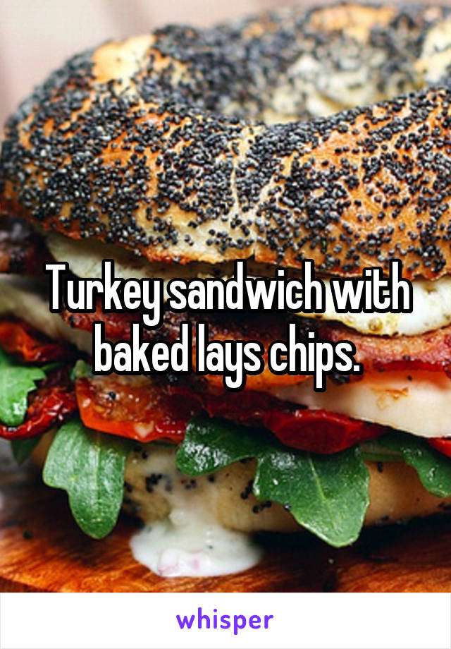 Turkey sandwich with baked lays chips.
