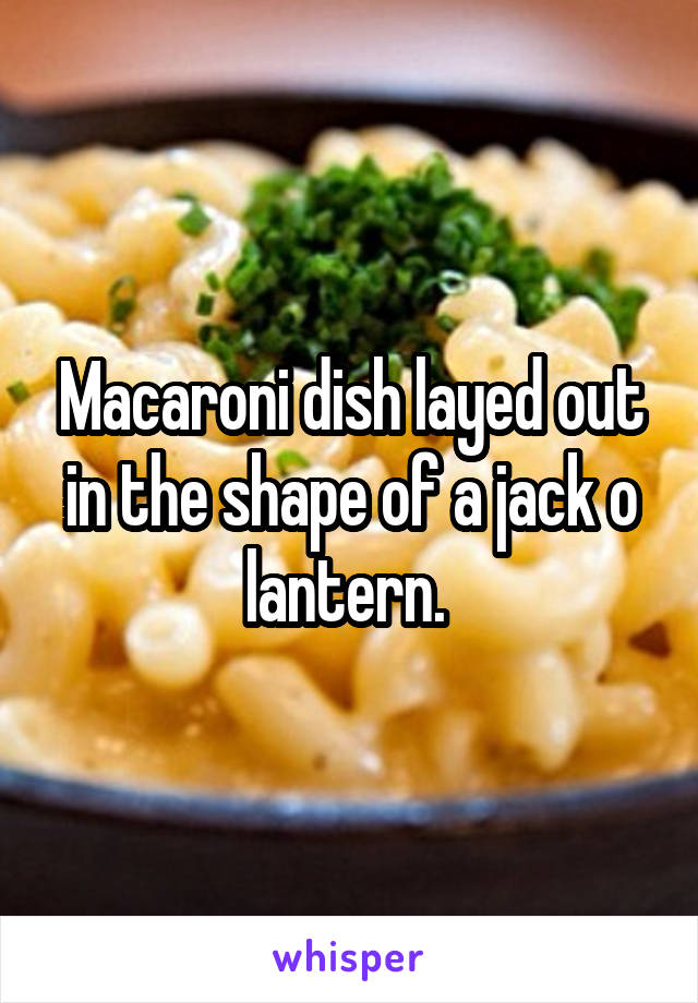 Macaroni dish layed out in the shape of a jack o lantern. 