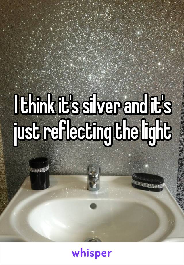 I think it's silver and it's just reflecting the light 