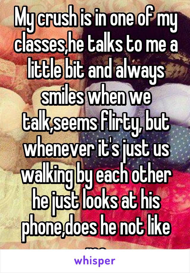 My crush is in one of my classes,he talks to me a little bit and always smiles when we talk,seems flirty, but whenever it's just us walking by each other he just looks at his phone,does he not like me