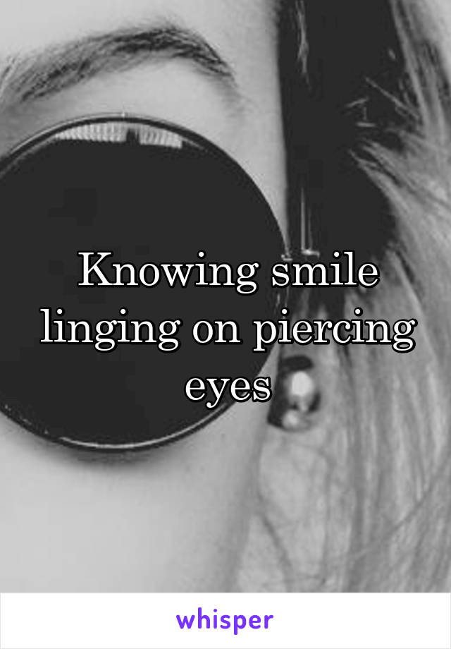 Knowing smile linging on piercing eyes