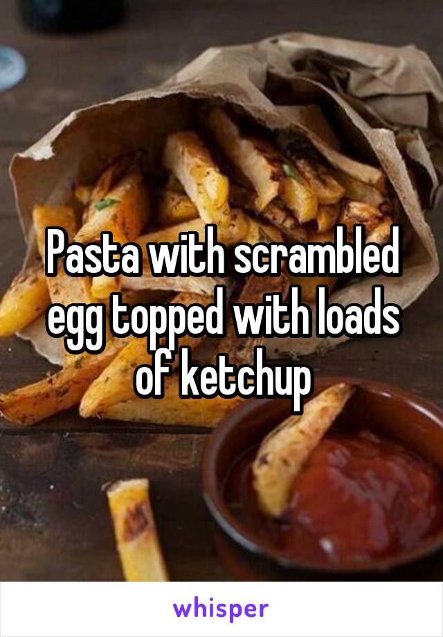 Pasta with scrambled egg topped with loads of ketchup