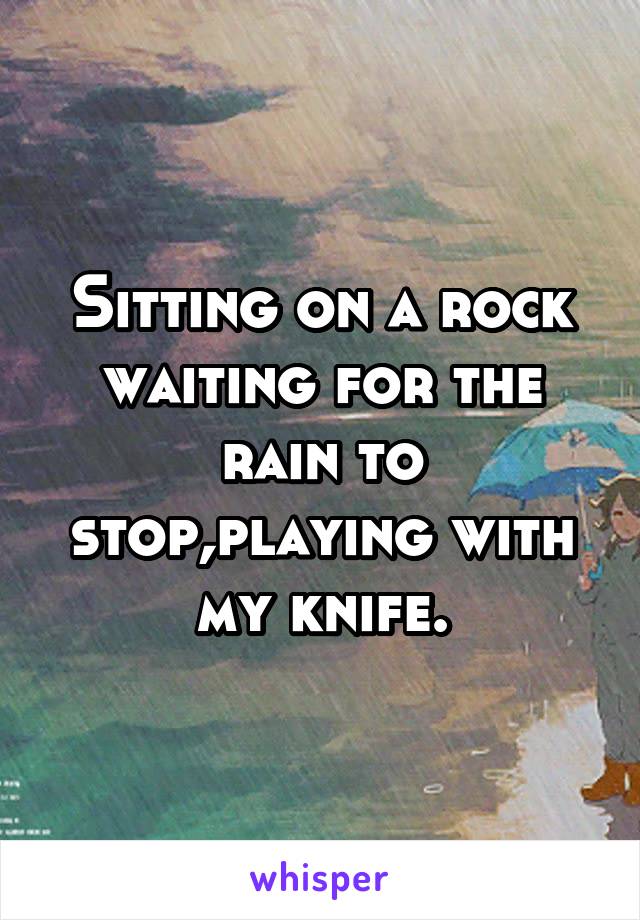 Sitting on a rock waiting for the rain to stop,playing with my knife.