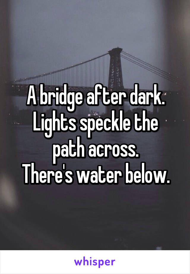 A bridge after dark.
Lights speckle the path across.
There's water below.