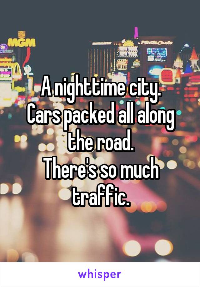 A nighttime city.
Cars packed all along the road.
There's so much traffic.