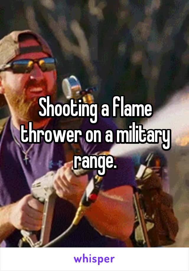 Shooting a flame thrower on a military range.