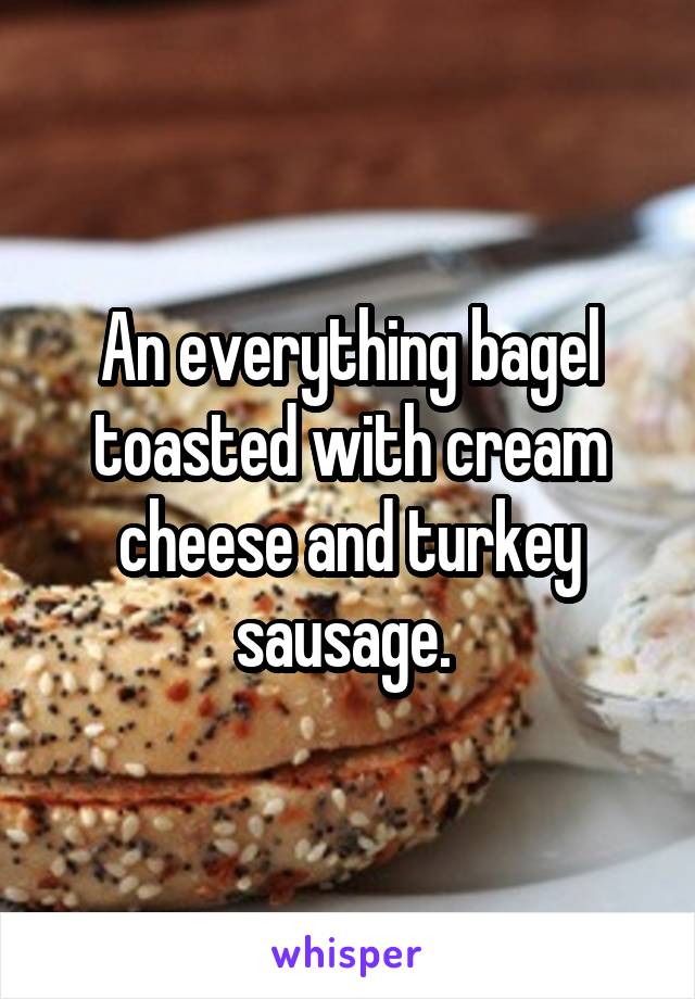 An everything bagel toasted with cream cheese and turkey sausage. 