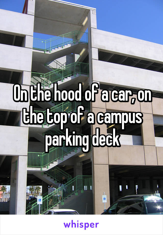 On the hood of a car, on the top of a campus parking deck