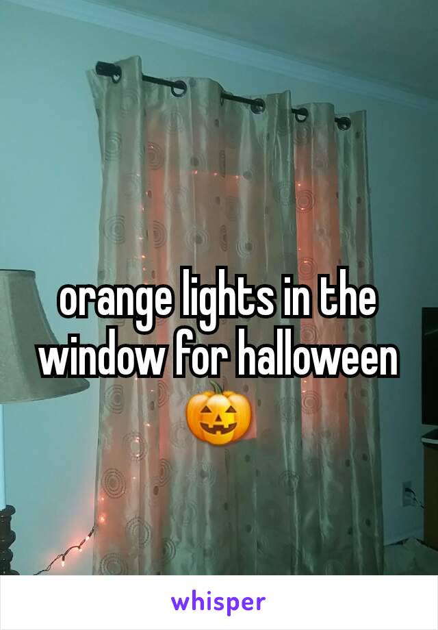 orange lights in the window for halloween 🎃