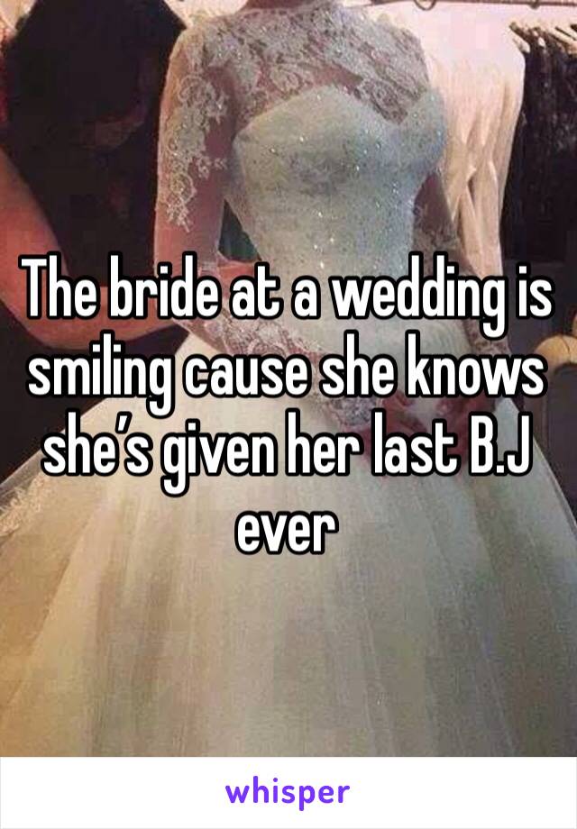 The bride at a wedding is smiling cause she knows she’s given her last B.J ever