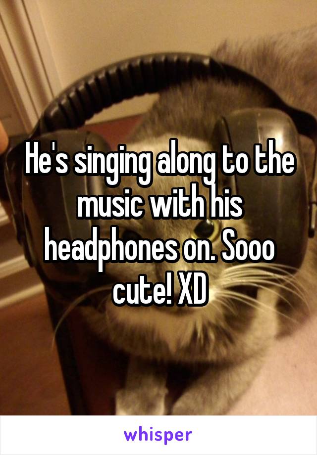 He's singing along to the music with his headphones on. Sooo cute! XD